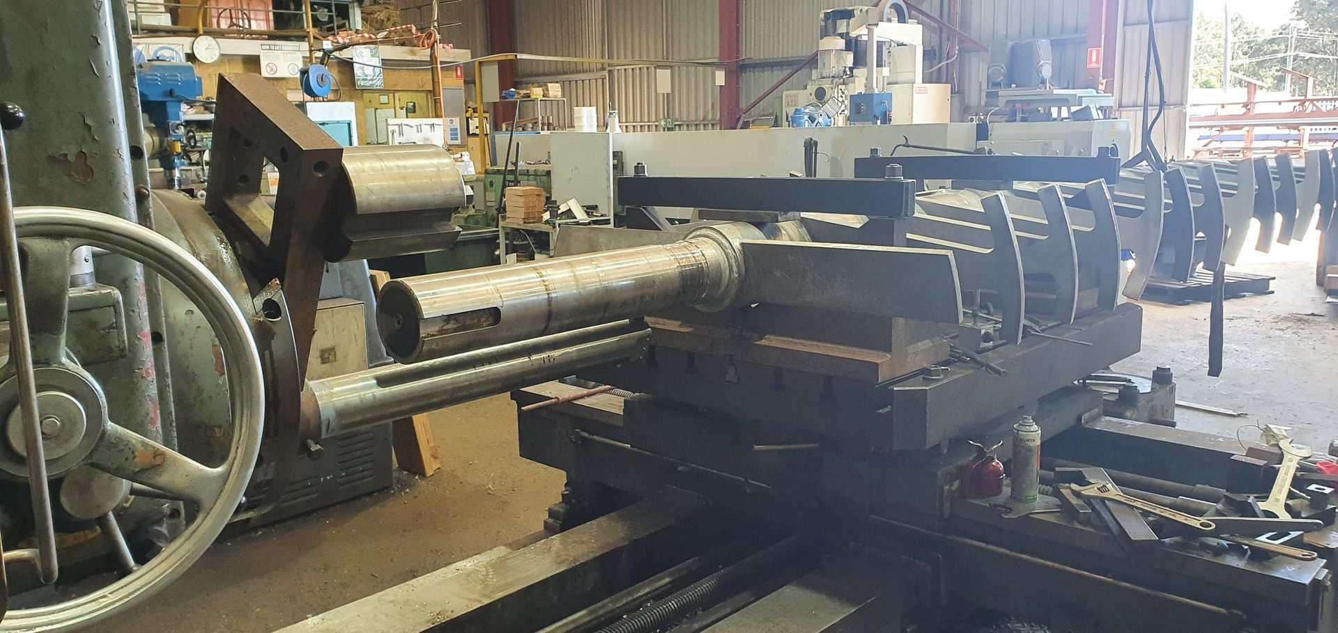 A machine is cutting a piece of metal in a factory.