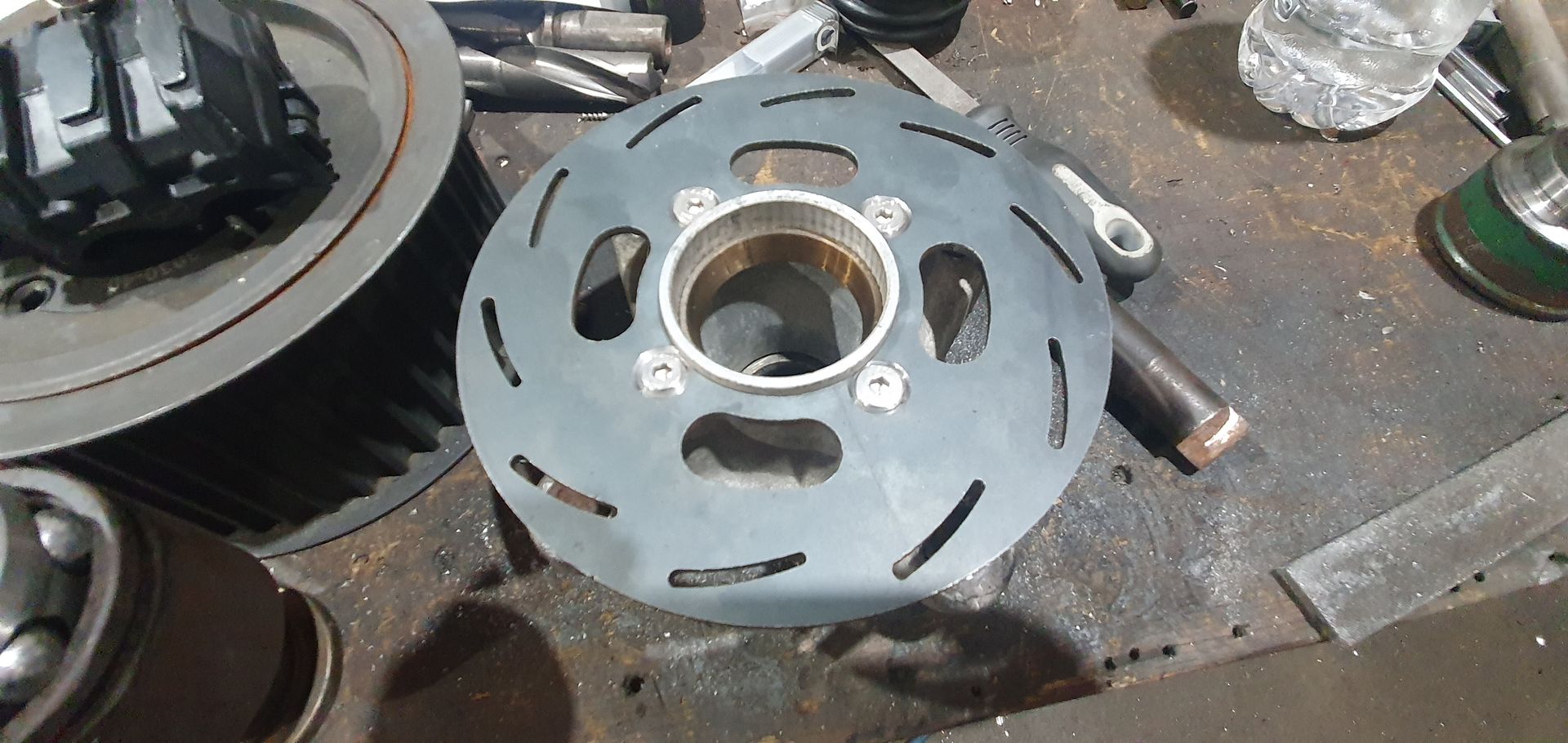 A piece of metal with holes in it is sitting on a table.