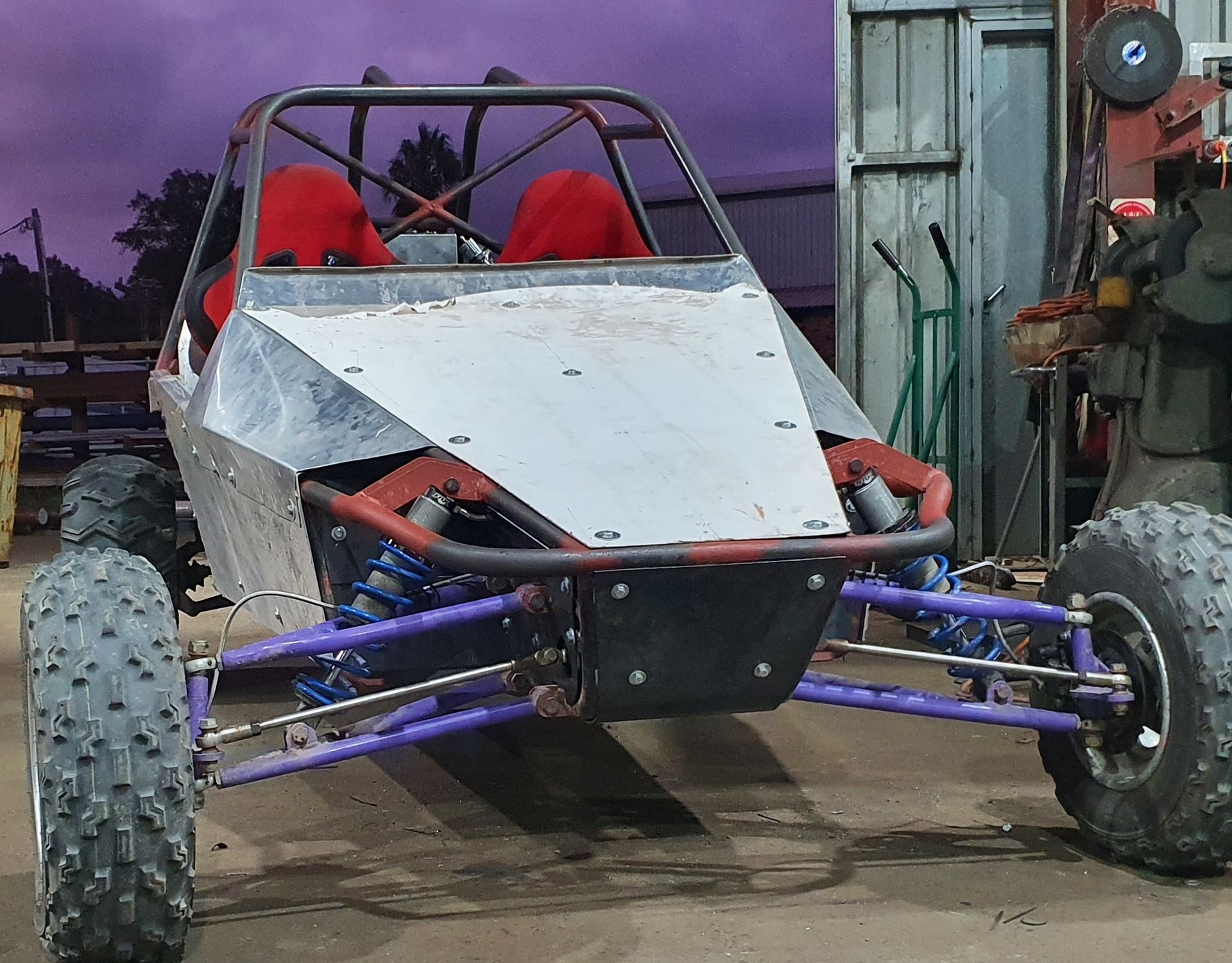 A buggy is parked in front of a purple wall