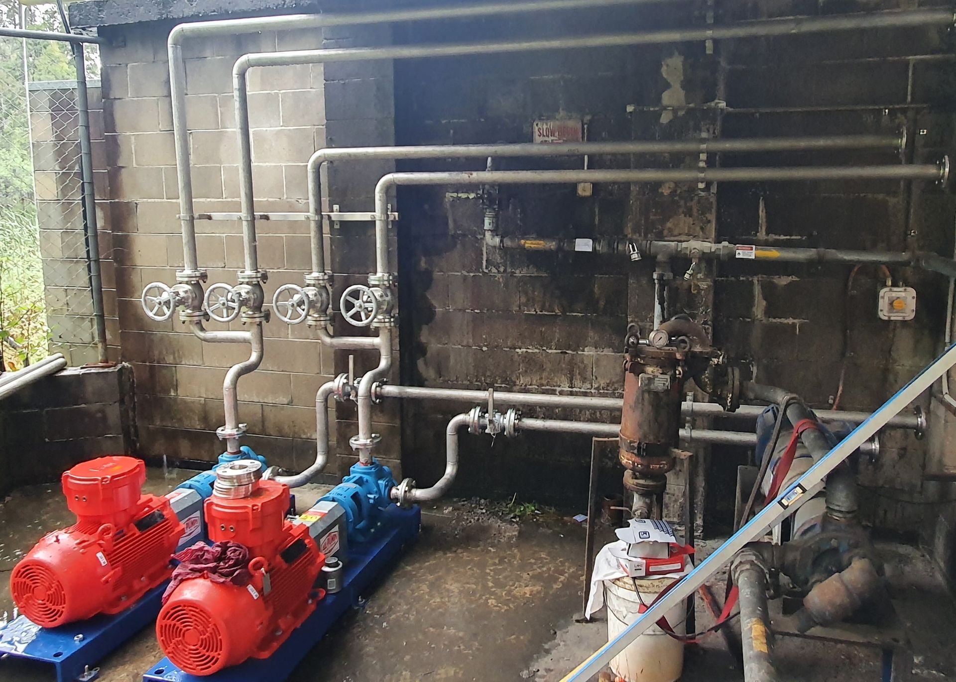 A room with a lot of pipes and pumps in it.