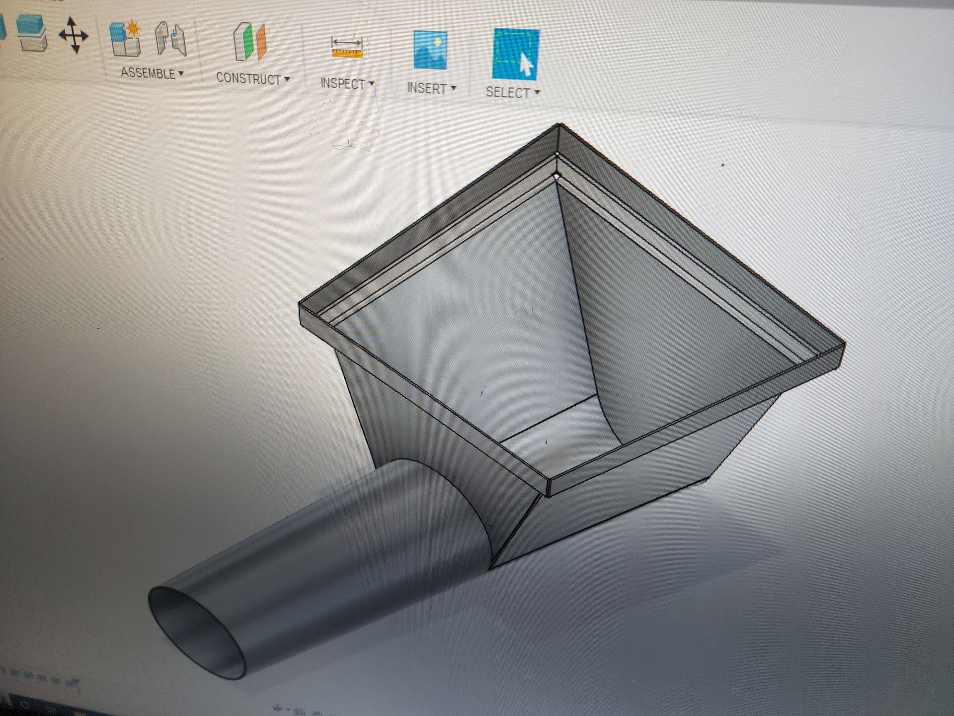 A computer screen shows a drawing of a metal object