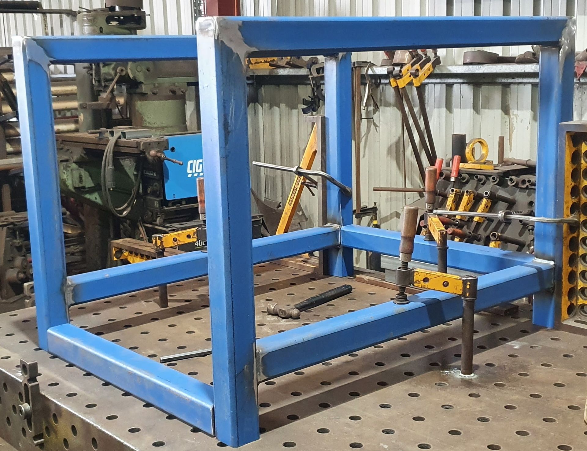 A blue metal frame is sitting on top of a metal table