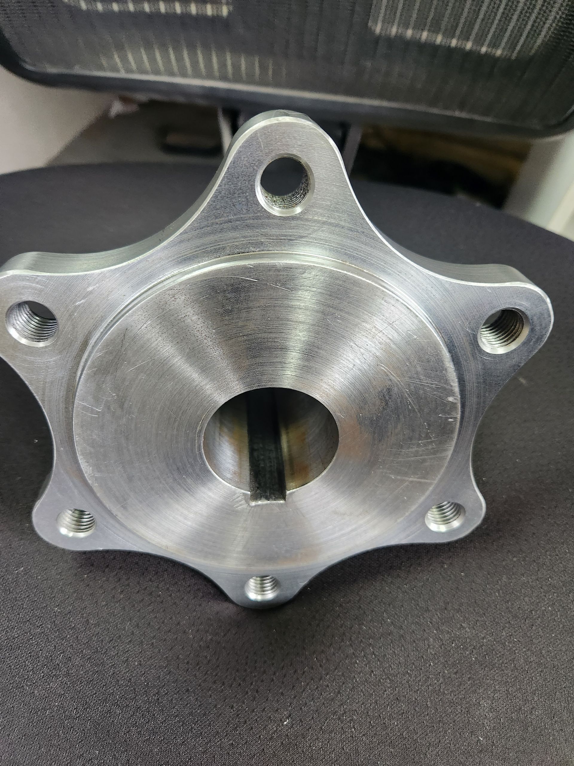A close up of a metal object with a hole in the middle on a table.
