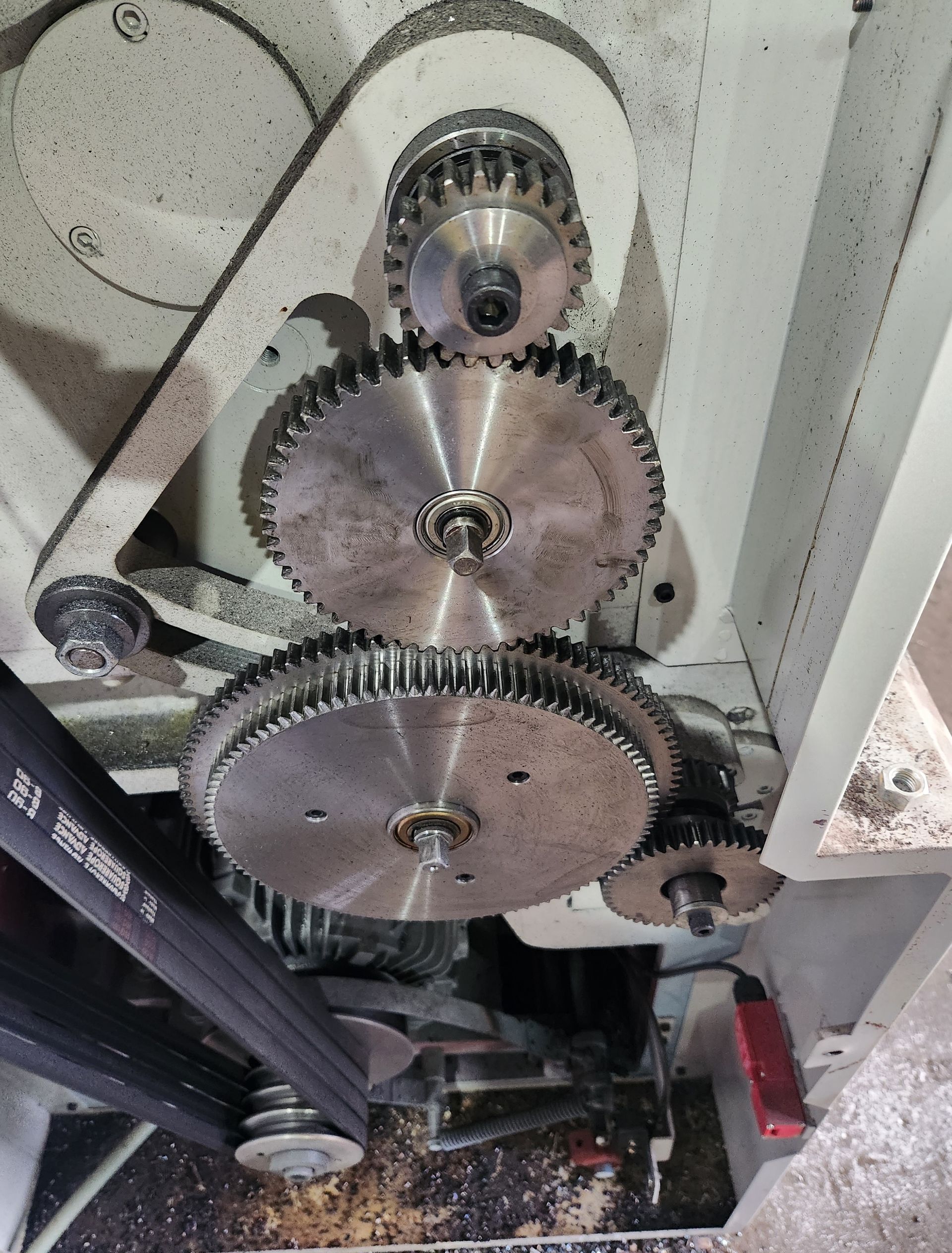 A close up of a machine with gears and a belt