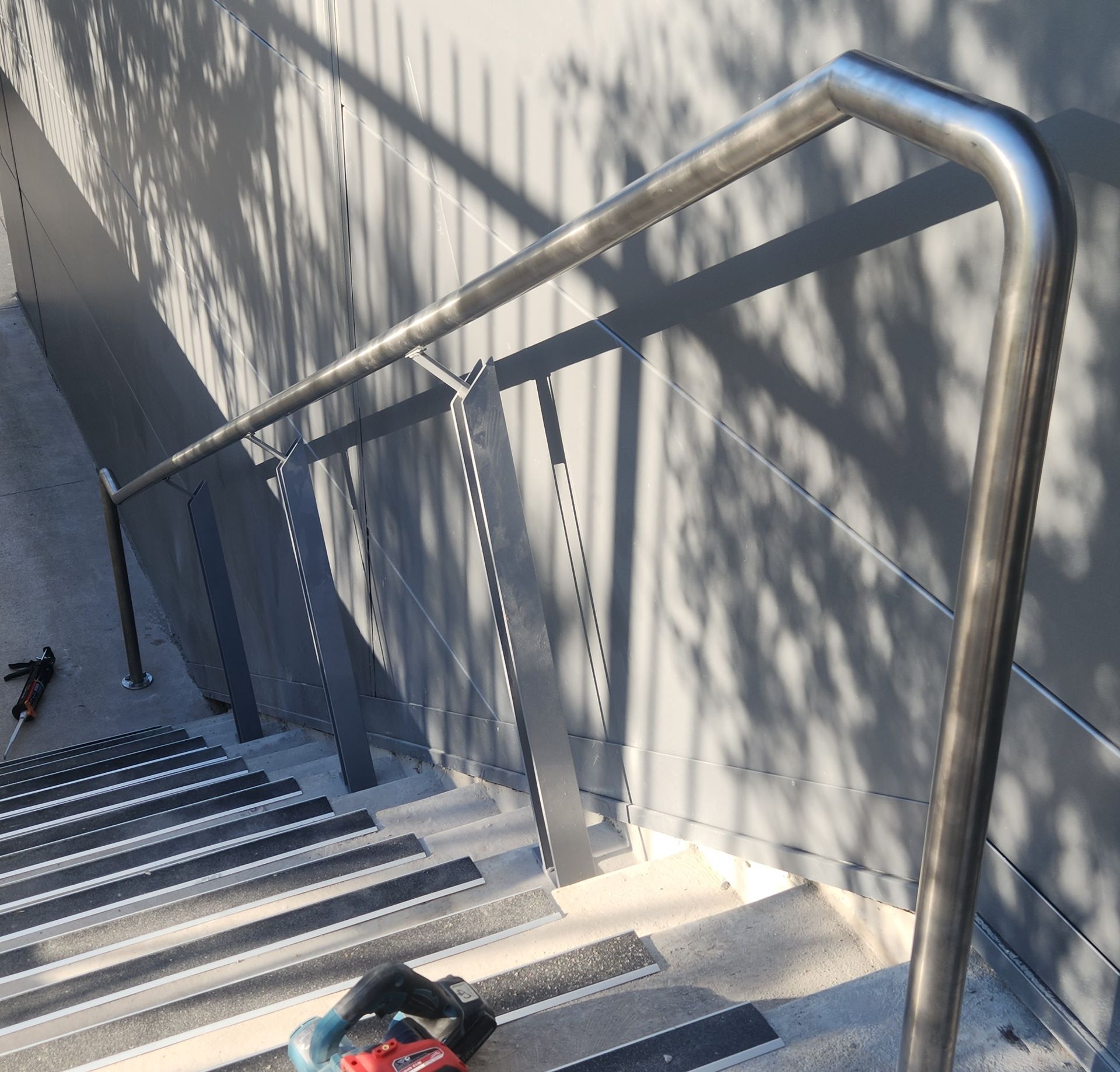 A stainless steel railing on a set of stairs