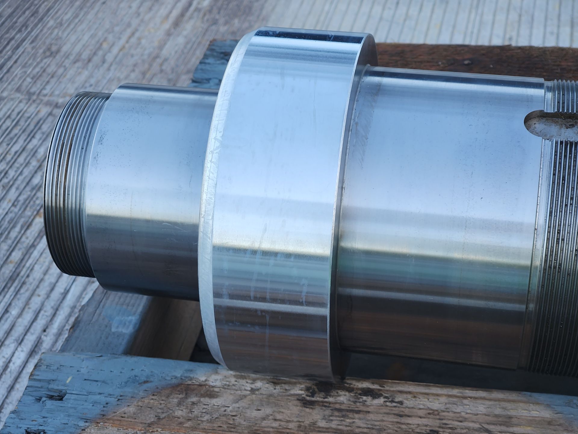 A large metal object is sitting on a wooden pallet
