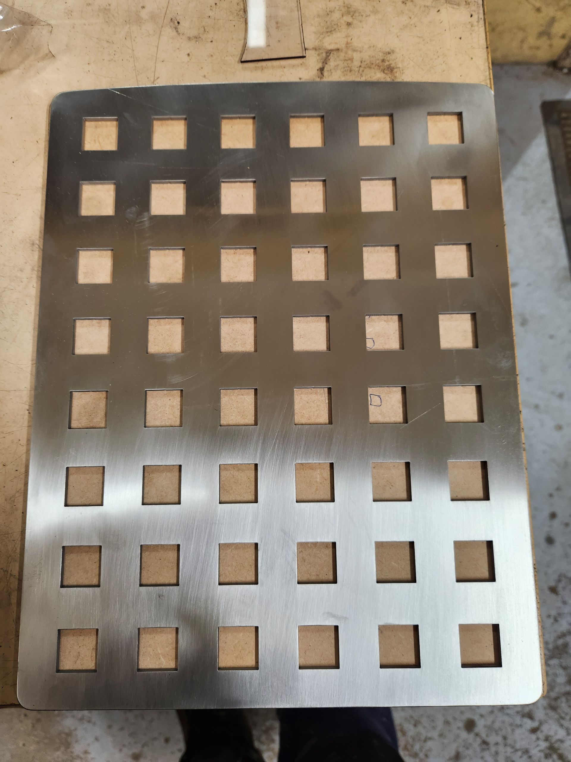 A piece of metal with square holes in it