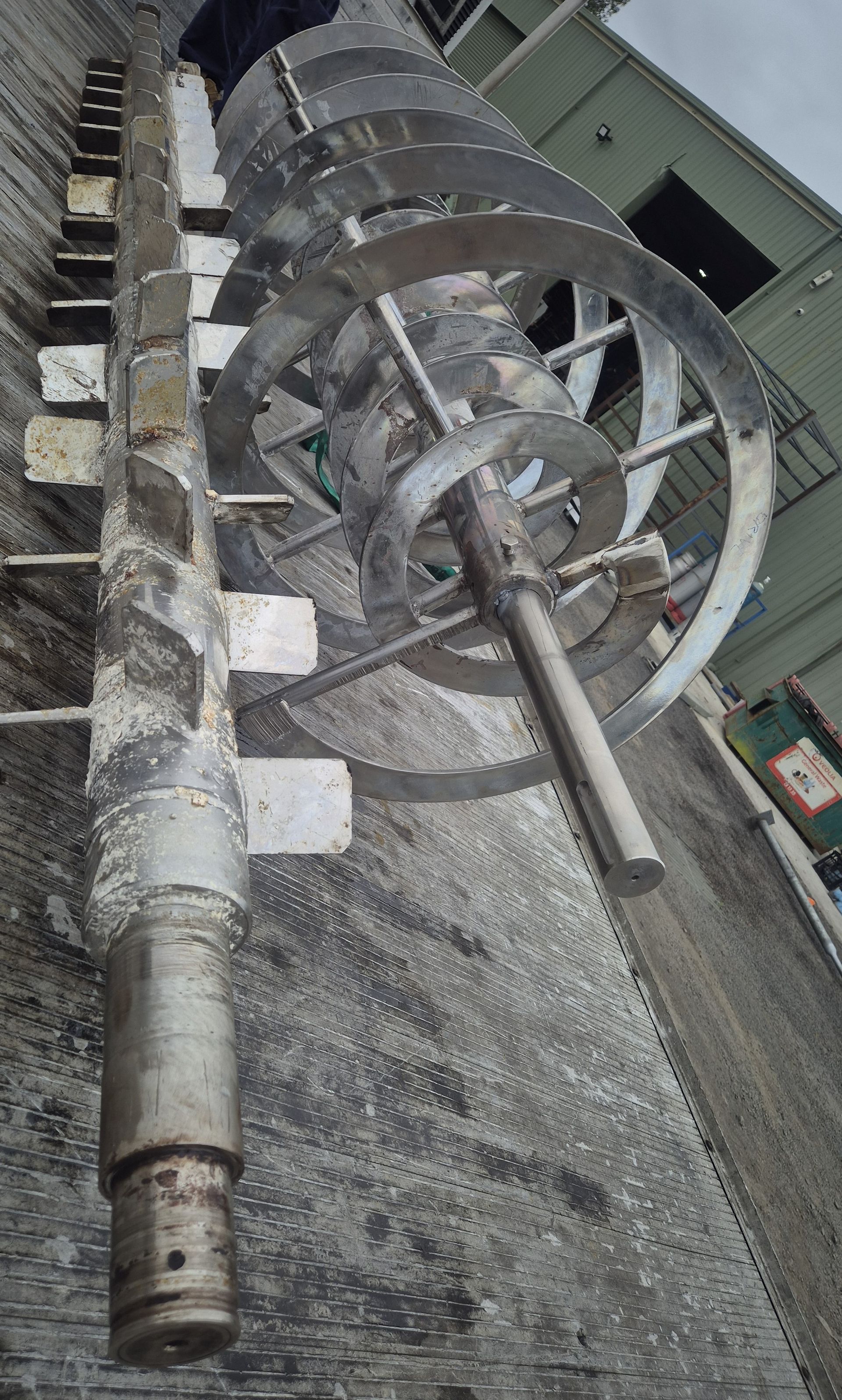 A large metal object is sitting on top of a concrete surface.