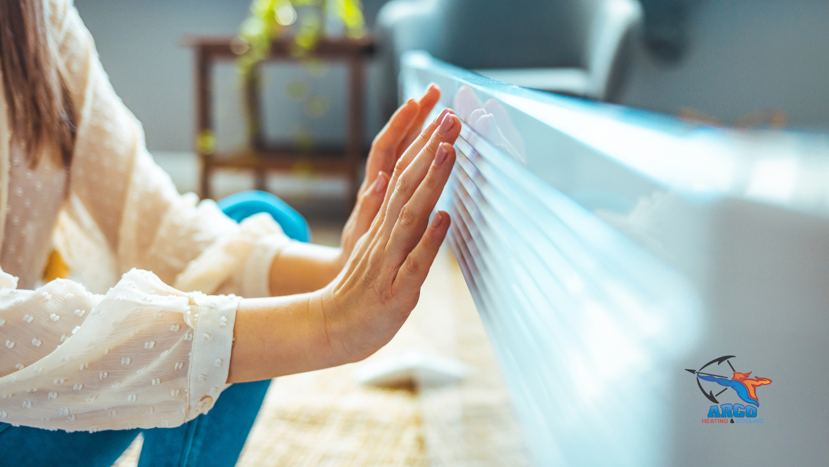 Woman's hands pushing against white object, possibly a dresser or cabinet, inside a home.