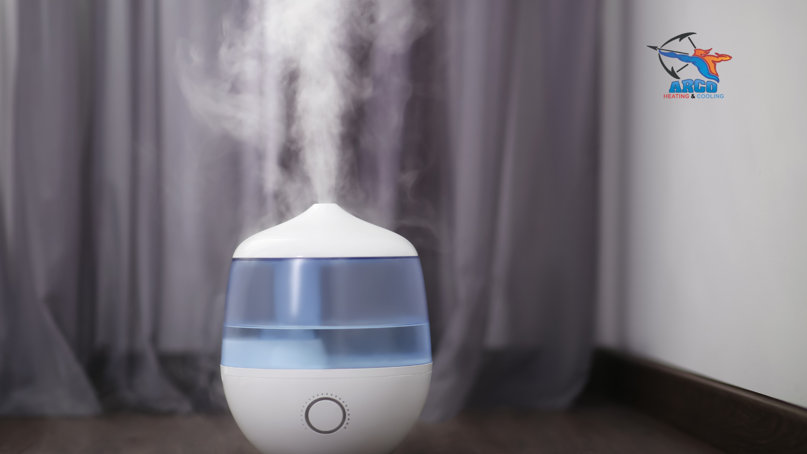 White humidifier releasing steam in front of gray curtains.