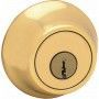 A close up of a brass door lock with a key in it.