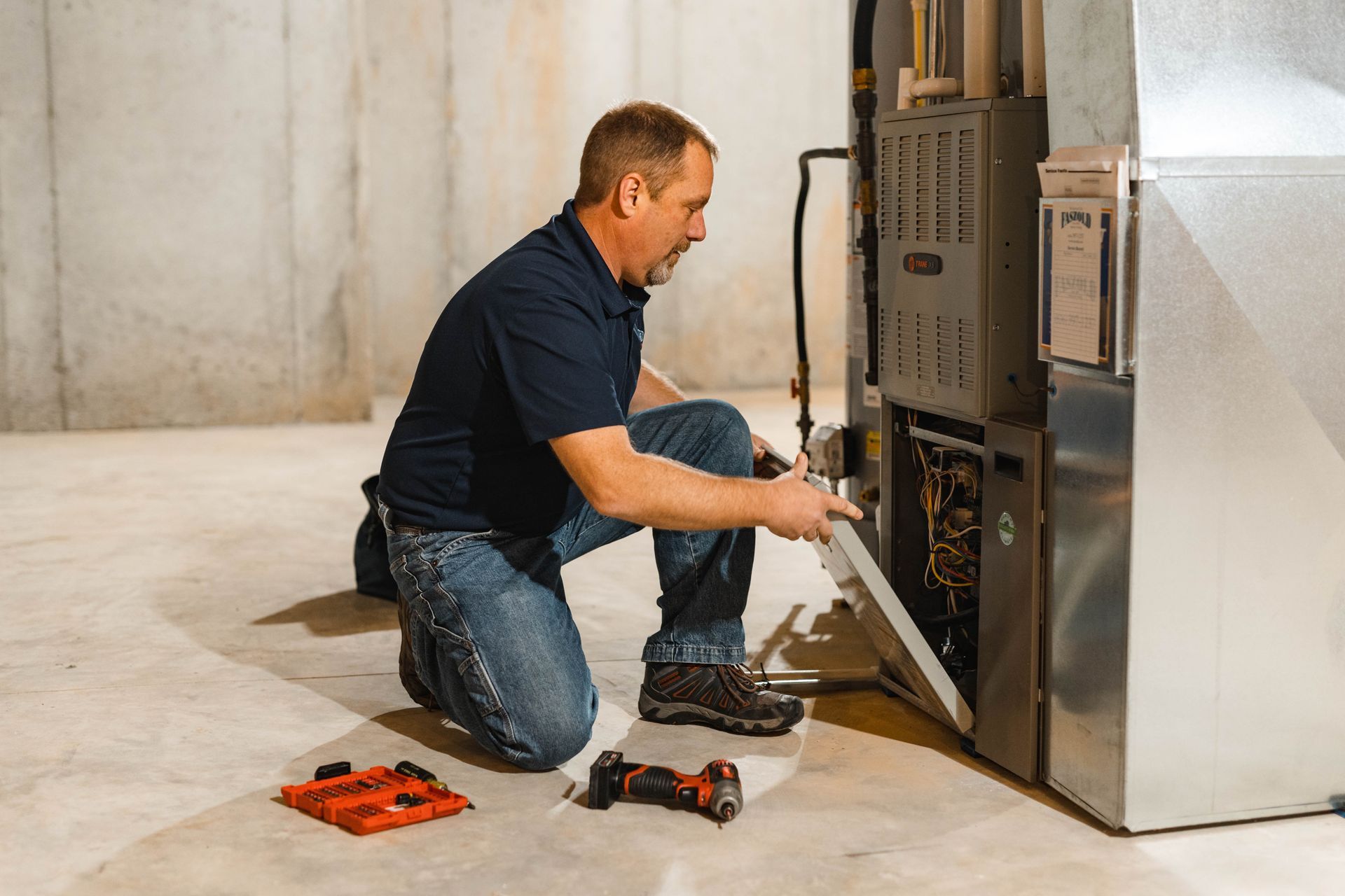 A man repairing a furnace