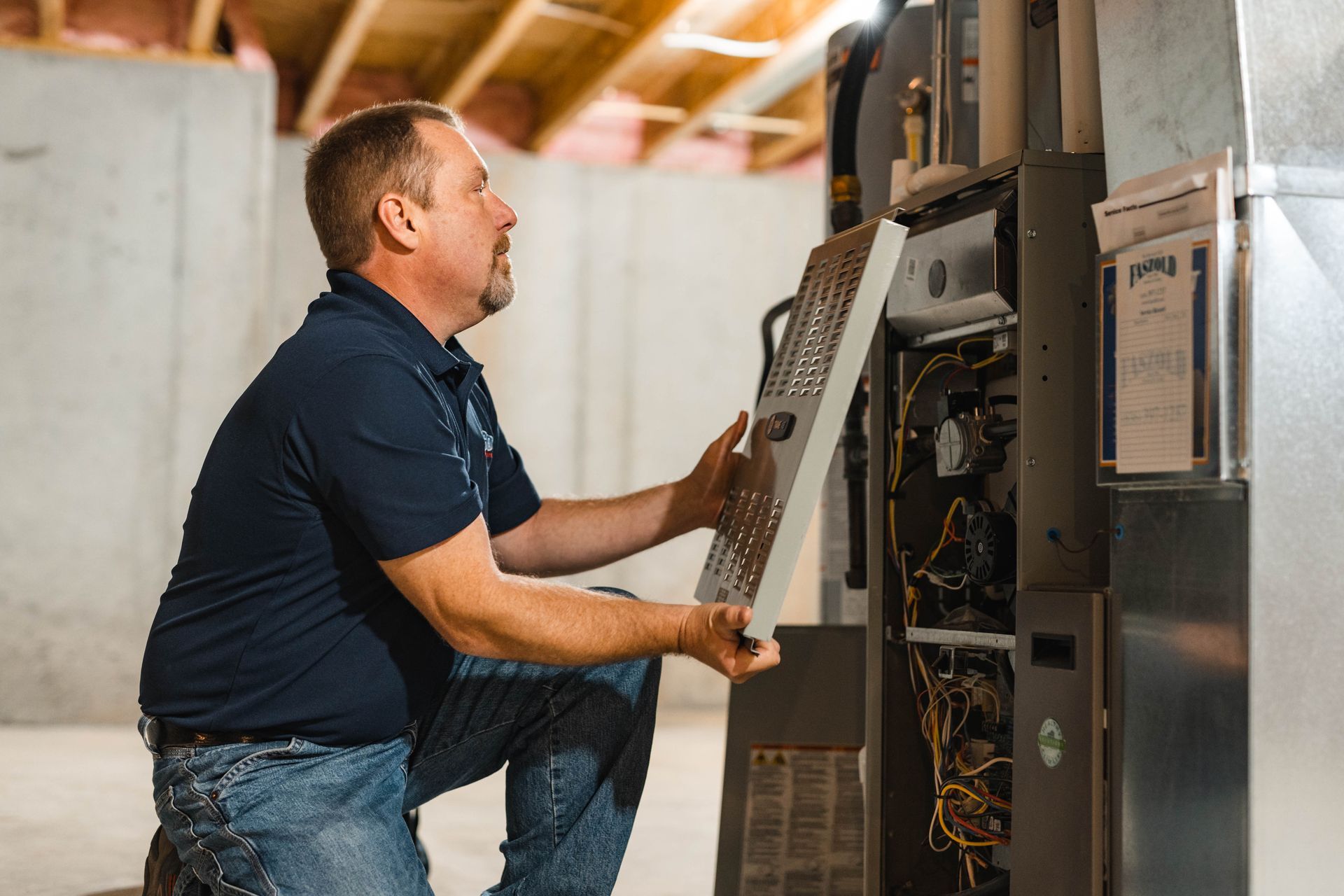A man working on a furnace
