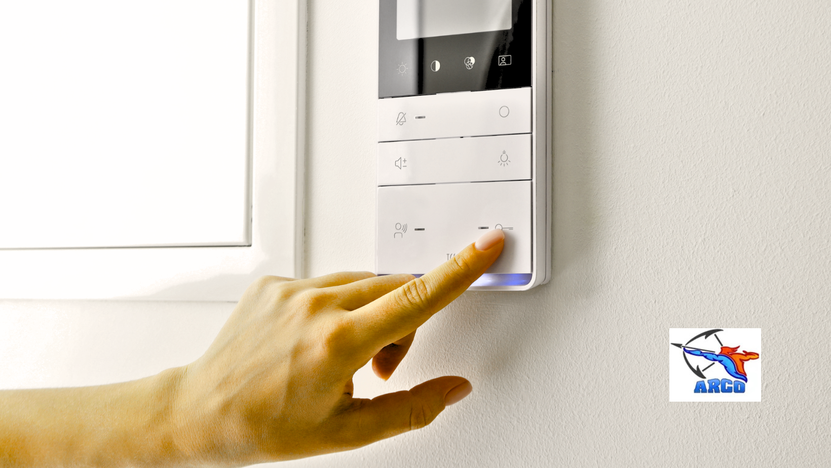 A hand adjusting a thermostat, with a zipped illustration showing sunny and snowy scenes, suggesting temperature control.