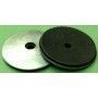 Two rubber washers are sitting next to each other on a green surface.