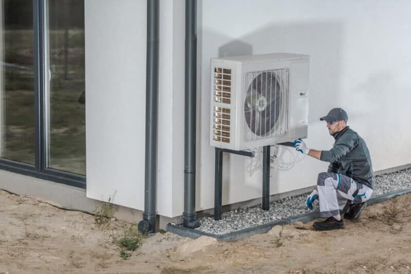 a man diagnoses a heat pump