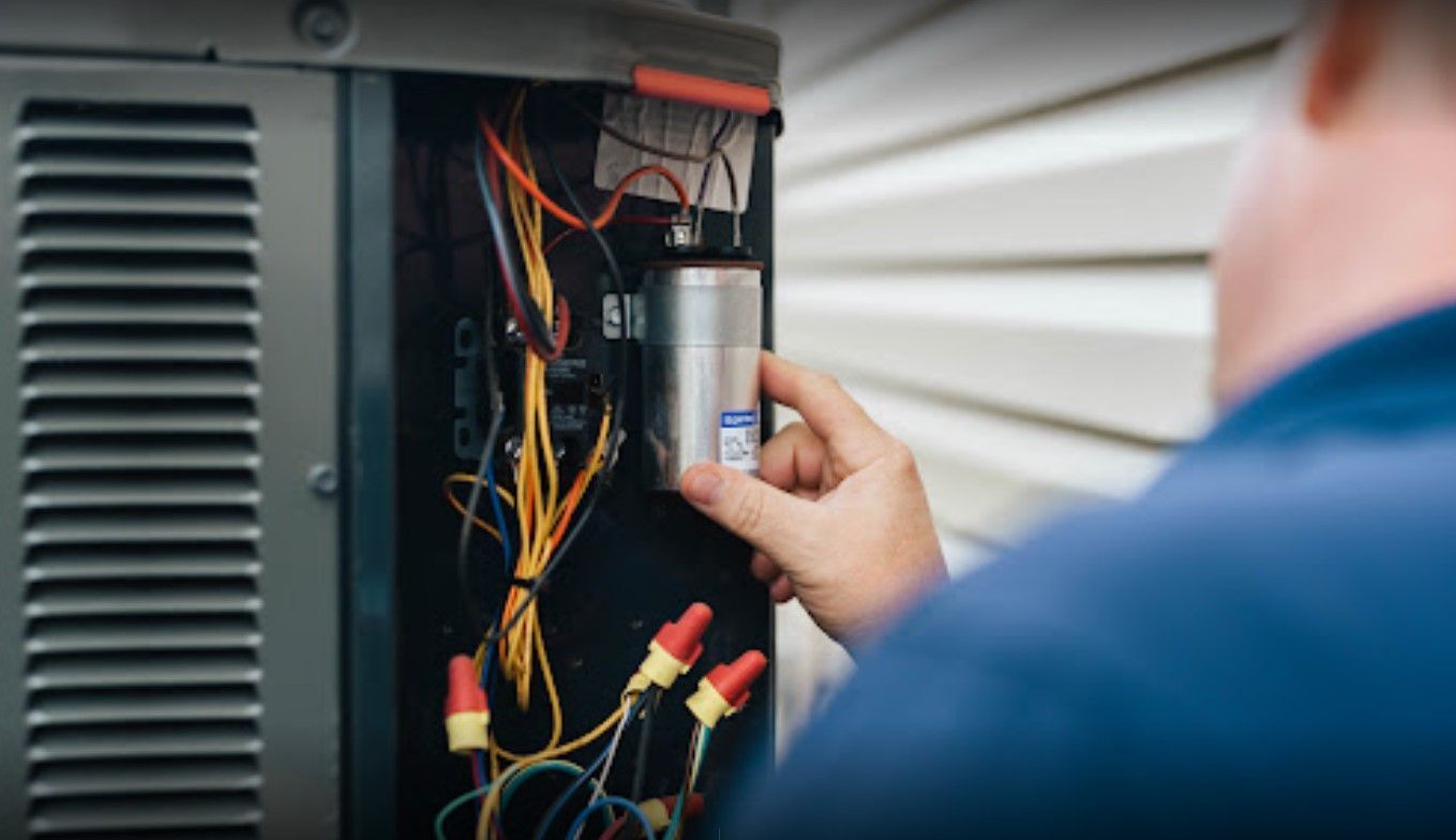 a man working on an outside air conditioner