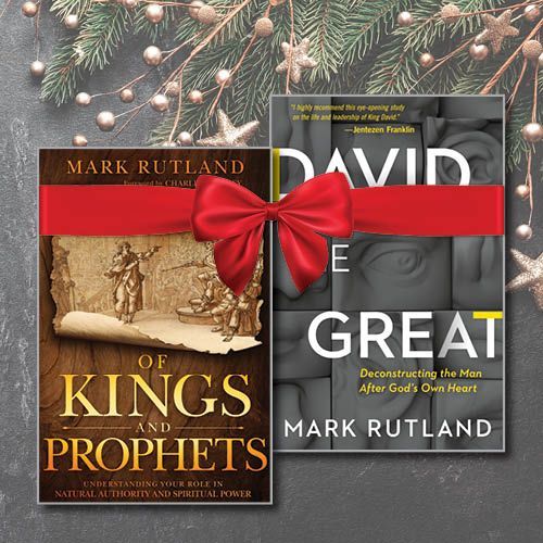 Two books, "Of Kings and Prophets" and "David the Great," tied with a red ribbon and holiday decorations.