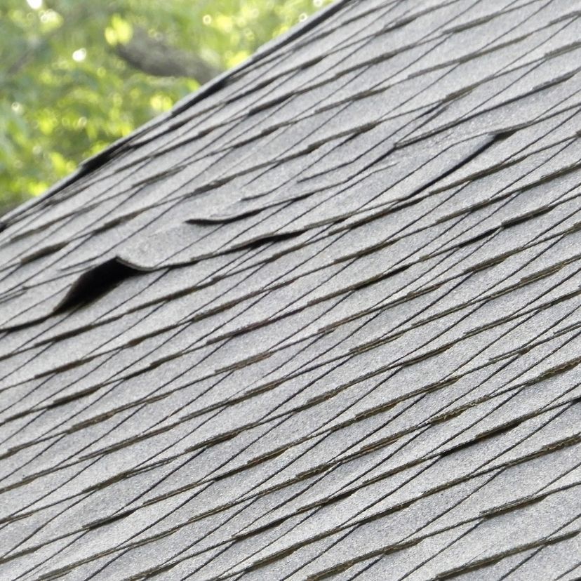 Rows of red clay roof tiles in a diagonal pattern, forming a textured rooftop surface.