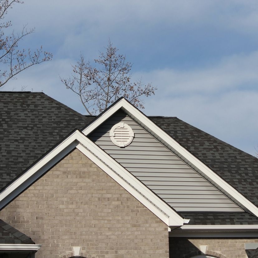 Red clay tile roof against a blue sky with one small chimney at the top left
