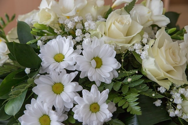 A close up of a bouquet of white flowers with baby 's breath.