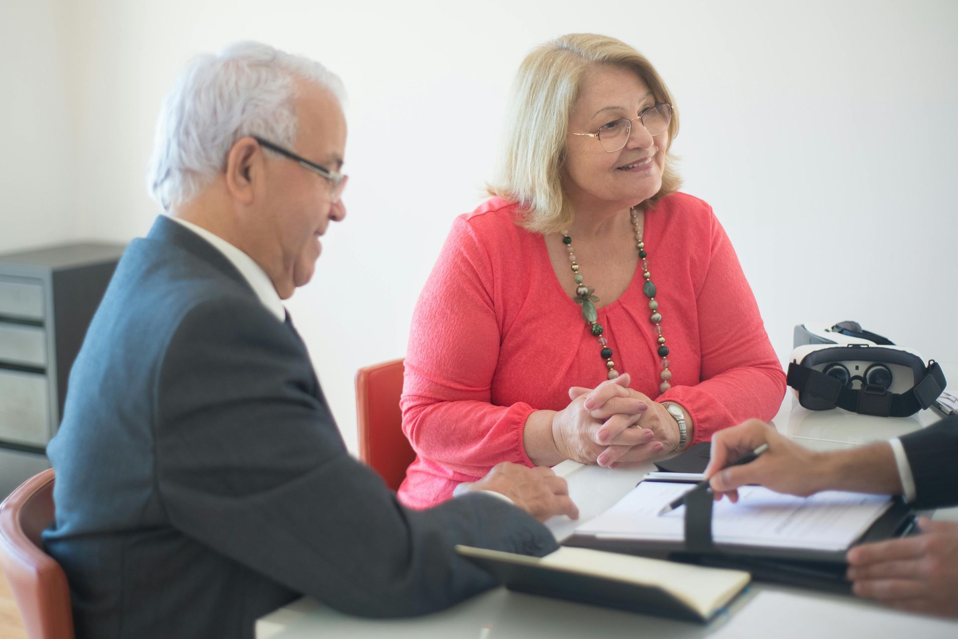 A pensioner couple engage in a talk with a broker.