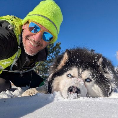 Brian taking a selfie with a dog in the snow.