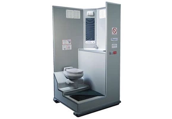 A portable, accessible toilet unit. Gray walls, step up to toilet, sink, and air vent.