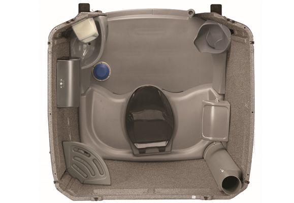 Overhead view of a portable toilet interior, gray with toilet seat, various tubes and compartments.