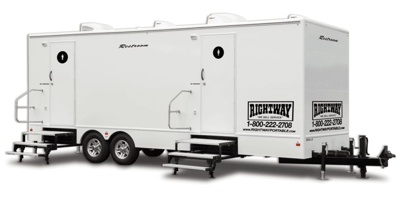 White, mobile restroom trailer with two entrances, steps, and wheels, labeled 