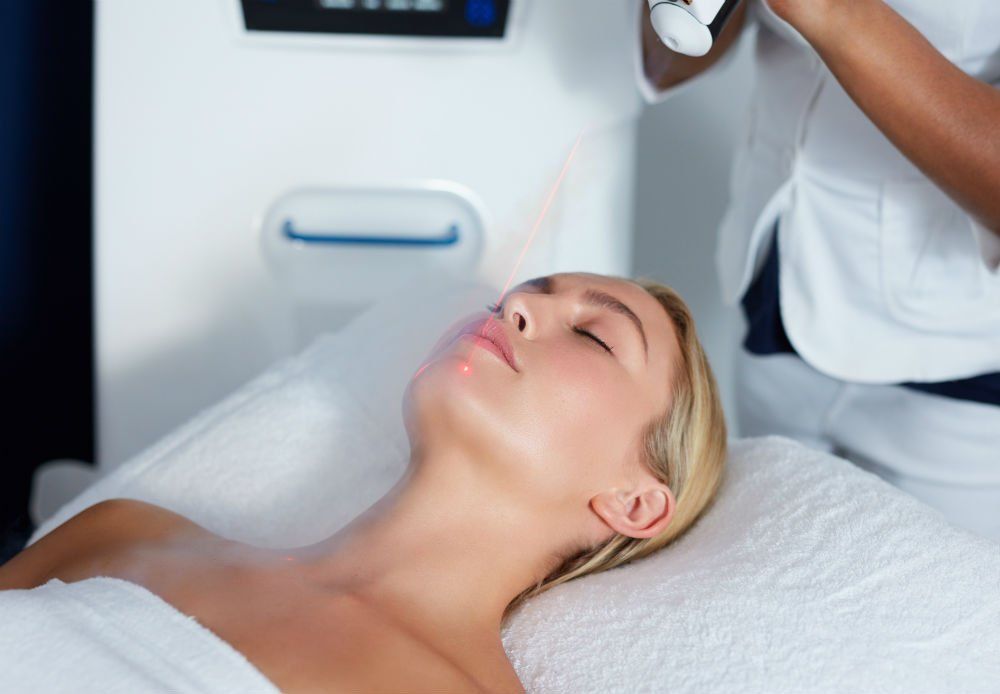 Young blond female getting a cryotherapy facial