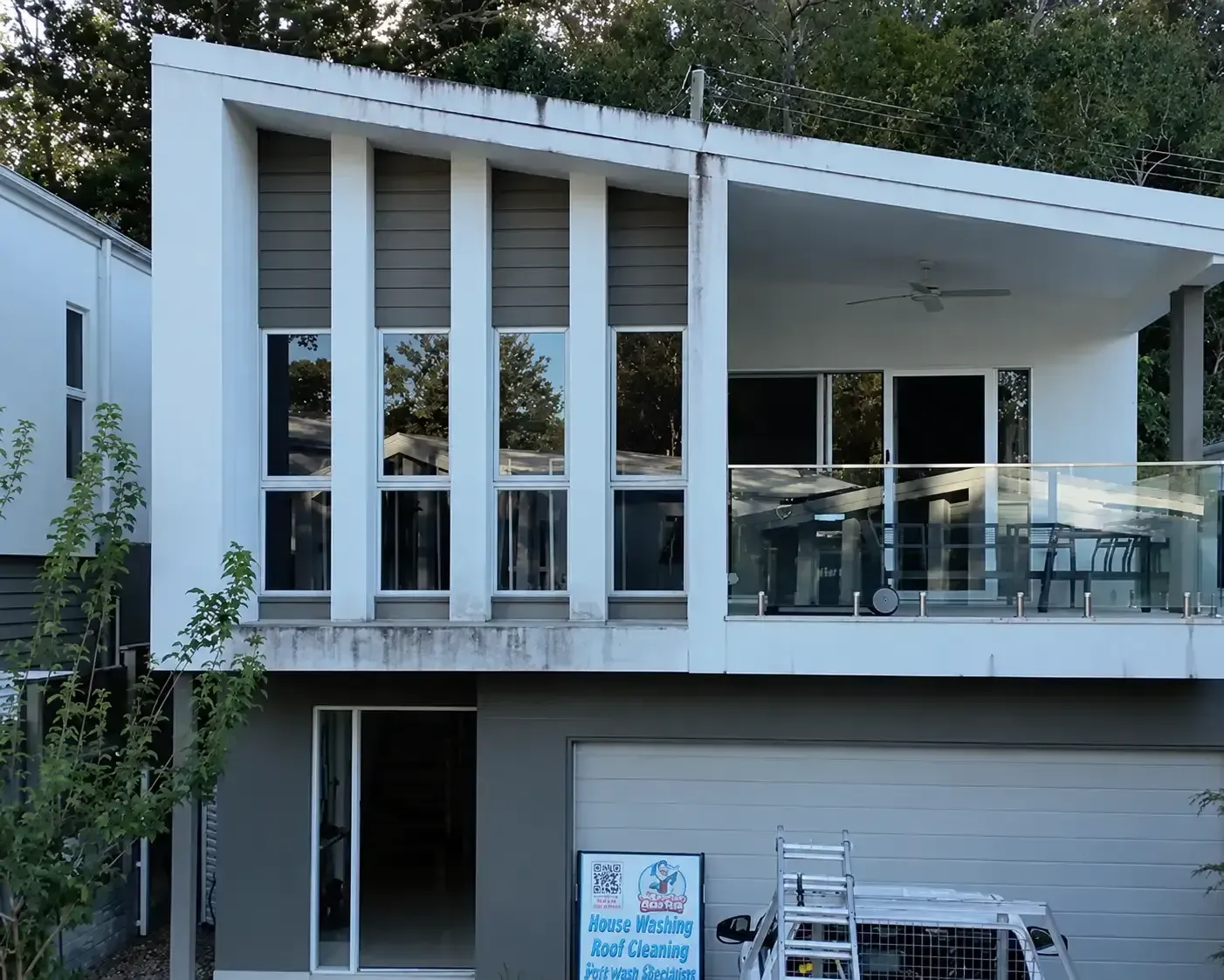 Mould streaking and green algae on white render before house washing in The Gap, Brisbane