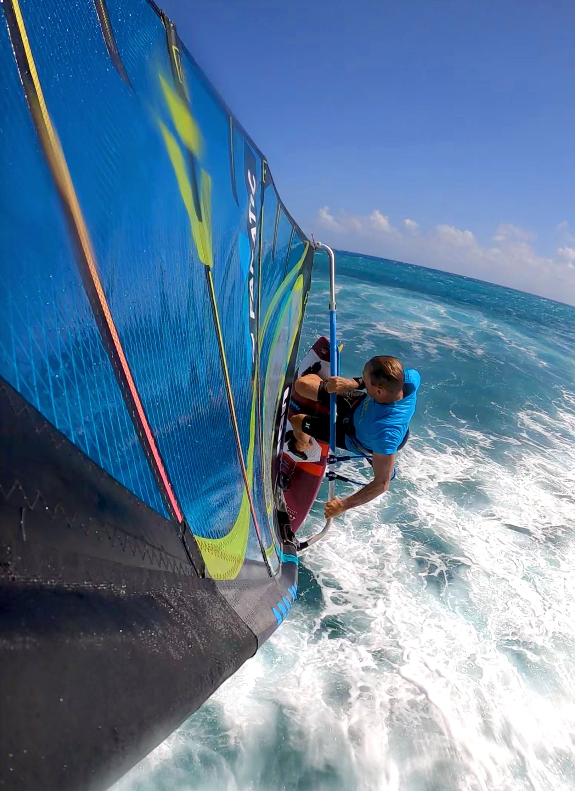 A man is riding a surfboard in the ocean.