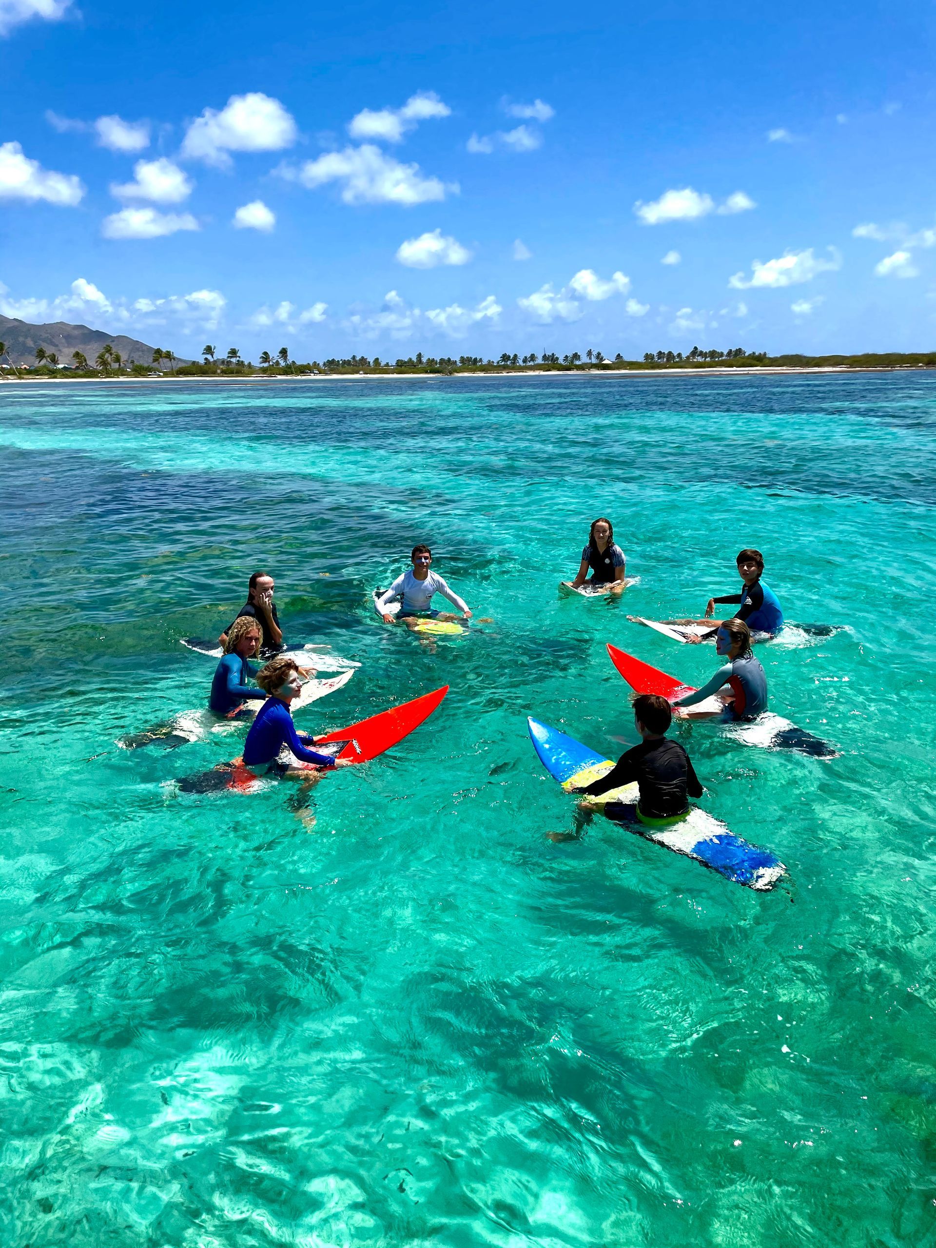 Surfers riding waves at SXM Sur Club on Galion Beach, Saint Martin