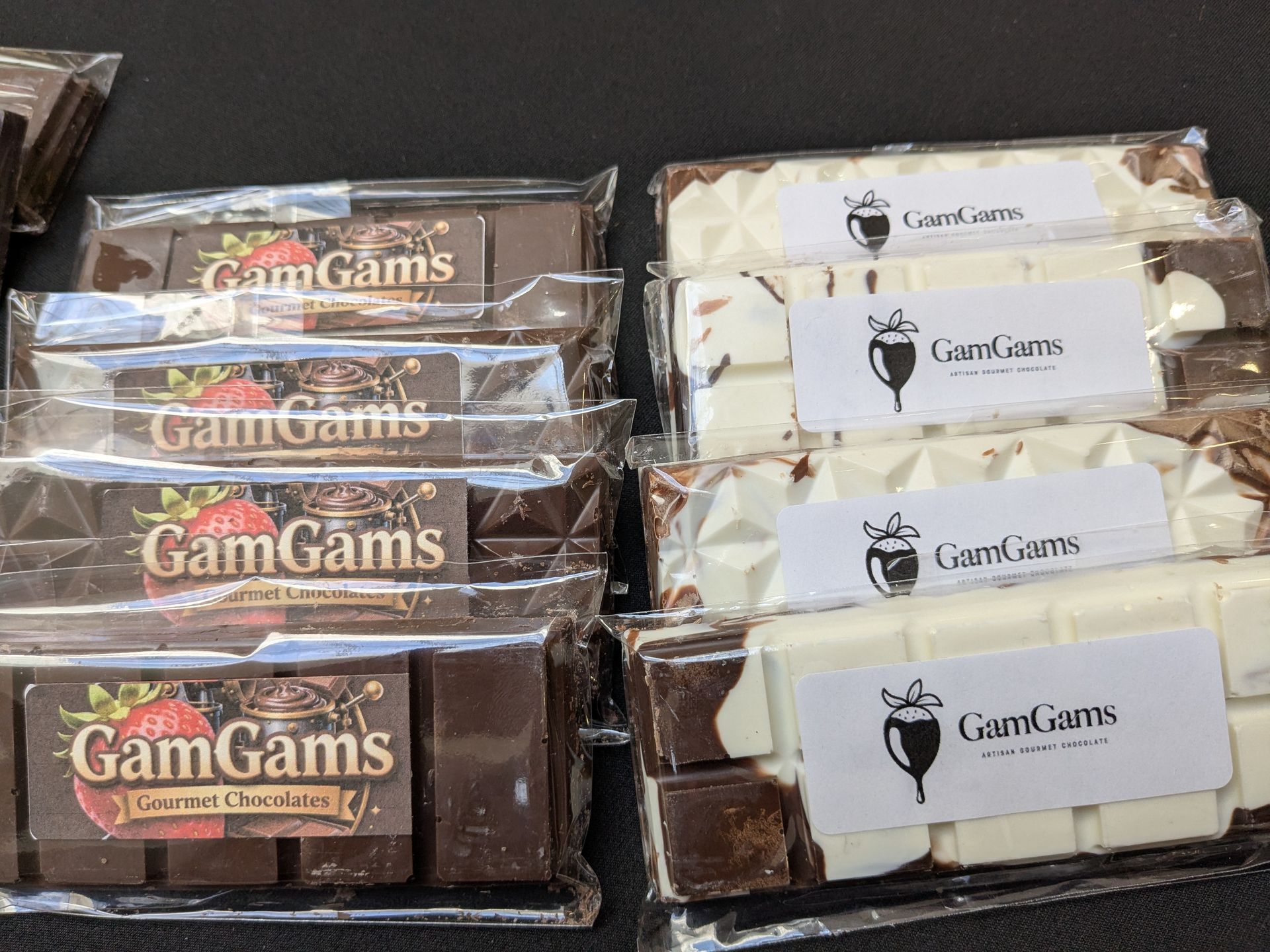 Assorted GamGams snack bars in clear wrappers, stacked in two rows on a flat surface.