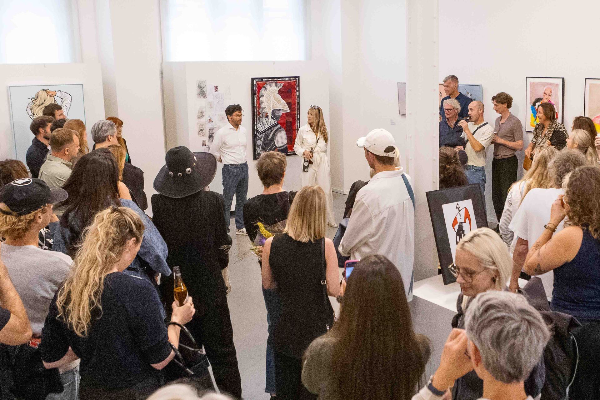 Amsterdam Modestad art gallery opening, viewing paintings on the walls.