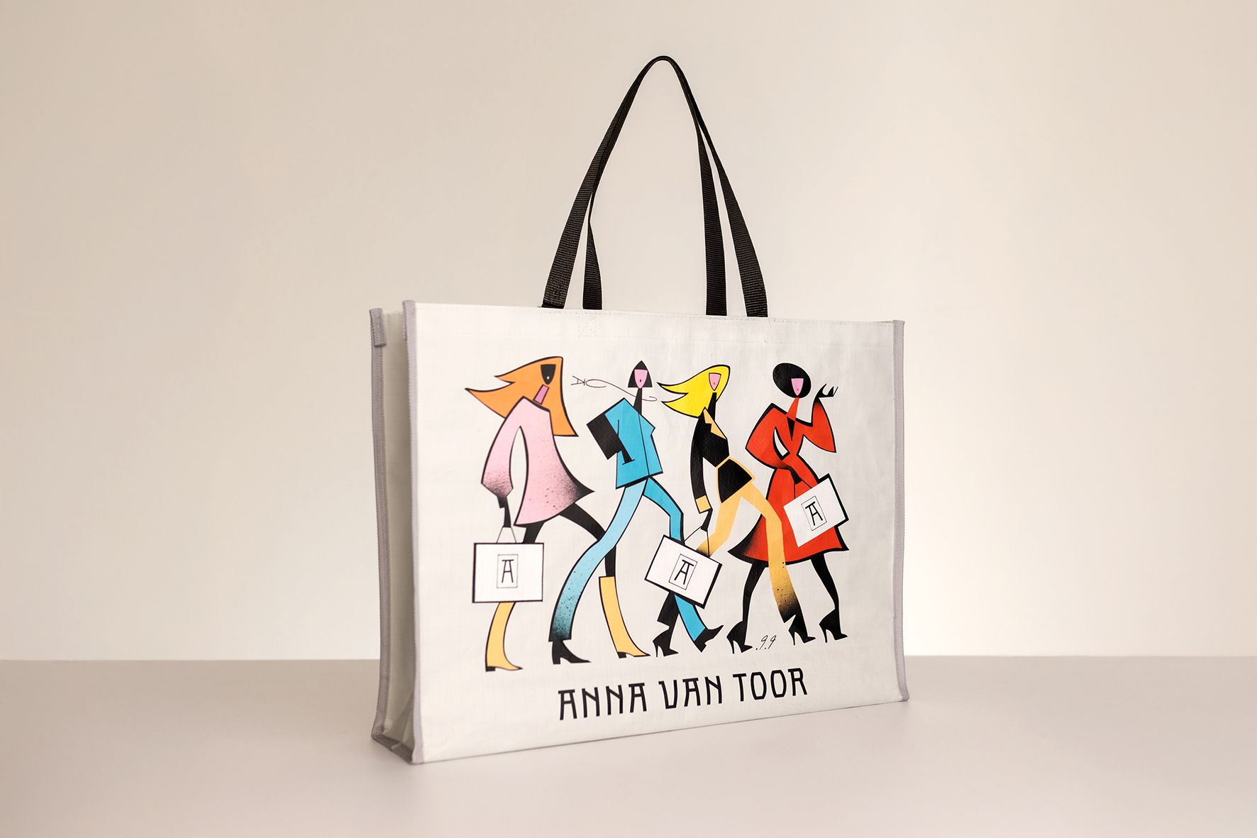 White tote bag with four stylized figures walking; black handles.