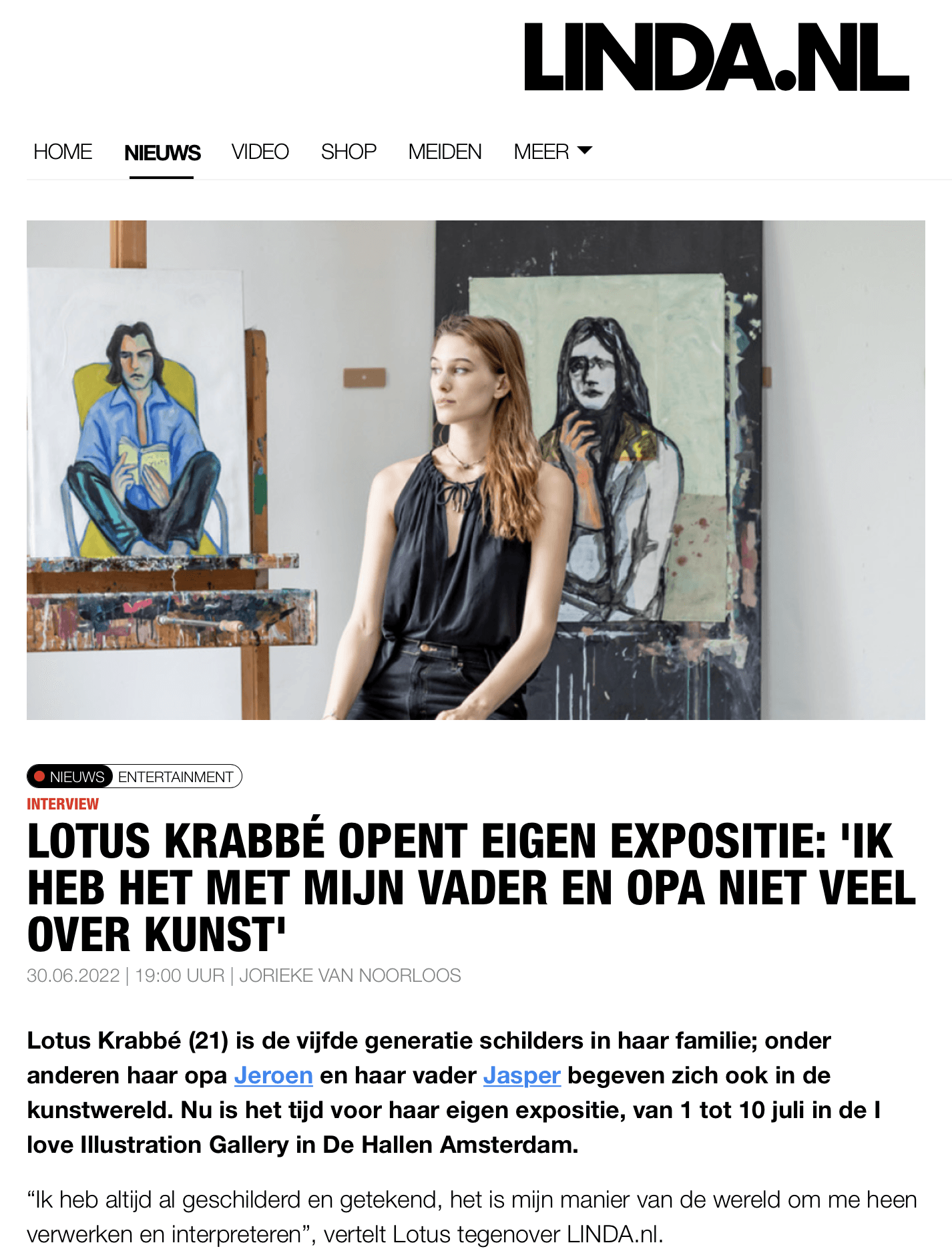 Woman in art gallery, standing between two paintings.