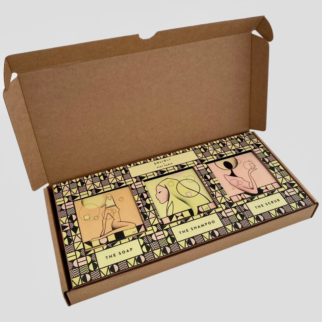 Open cardboard box with three art prints inside, each with a minimalist animal illustration in brown and beige tones.
