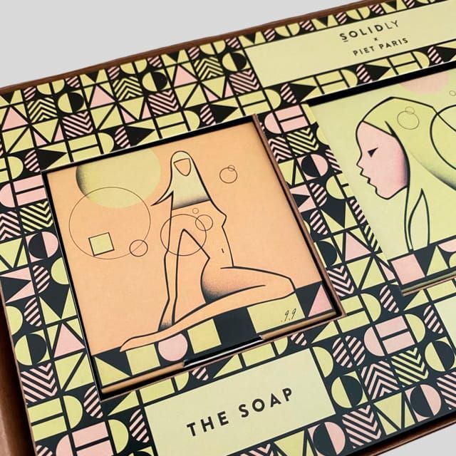 Boxed soap set with geometric design and artwork of stylized figures.