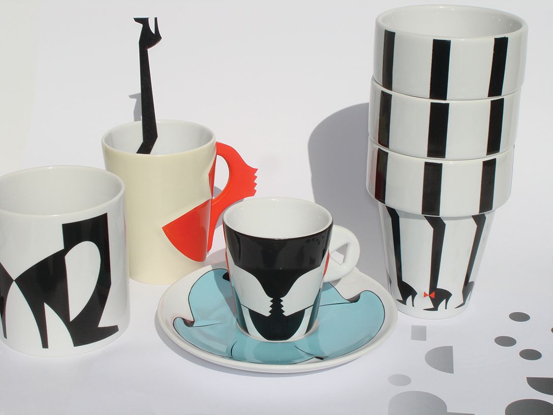 A collection of patterned coffee cups and saucers with black and white designs.