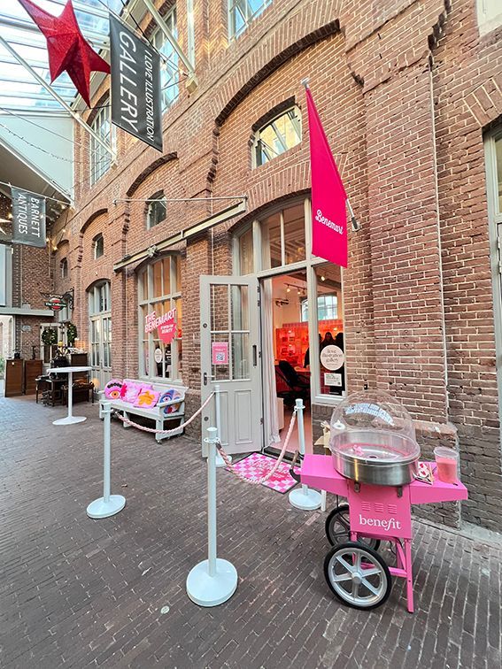 Pink cotton candy cart outside a gallery in a brick building. Rental Space Venue at De Hallen Amsterdam