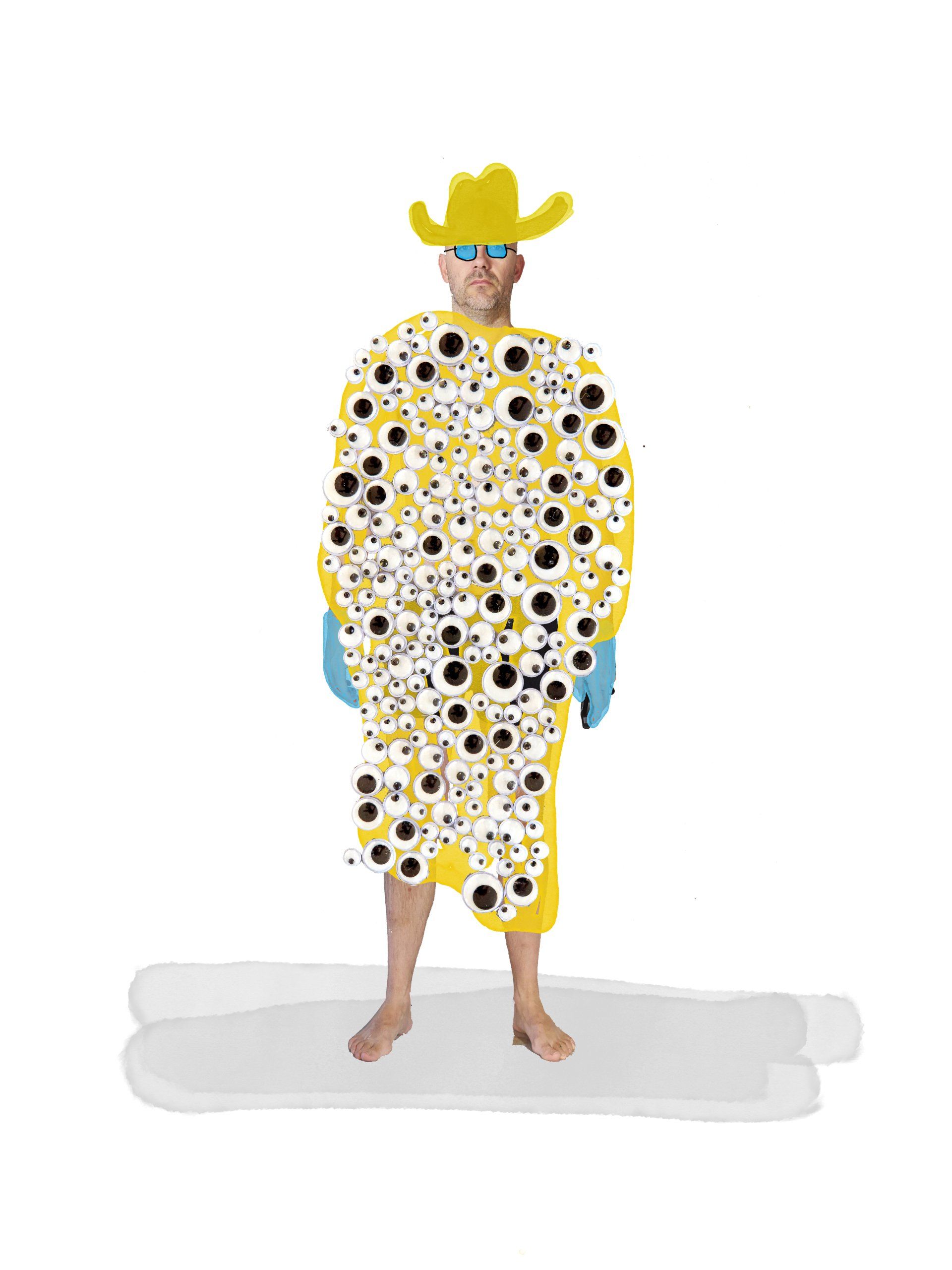 Person in yellow outfit covered in eyes, wearing a yellow hat, standing on a gray surface, with blue gloves.