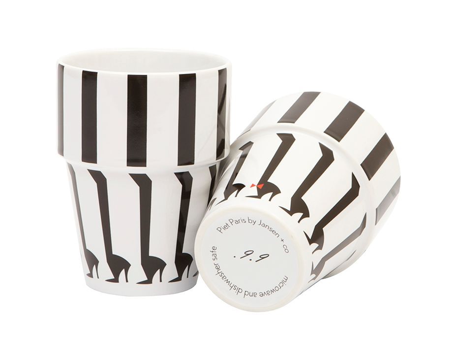 Two white ceramic cups with black vertical stripes and giraffe silhouettes.