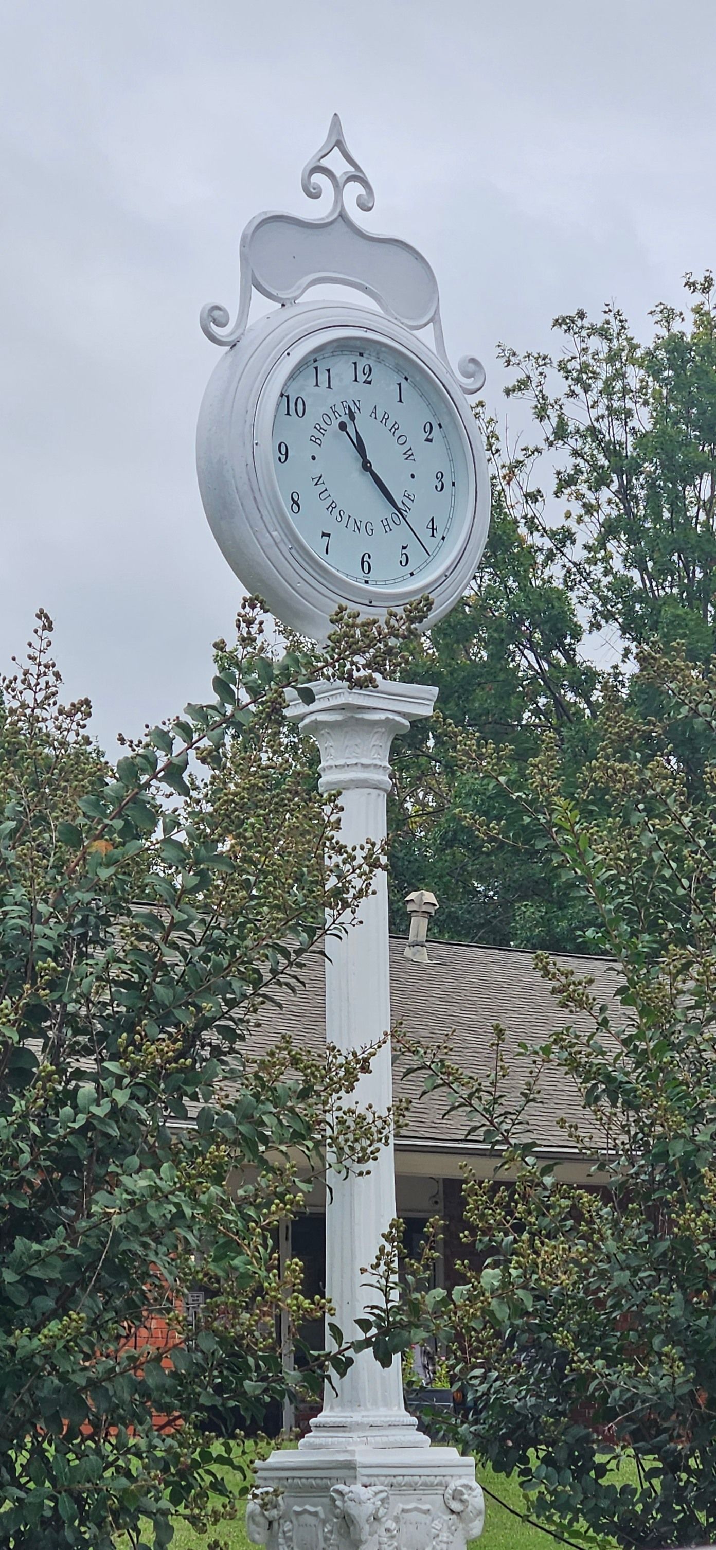 A wooden clock with roman numerals on the face