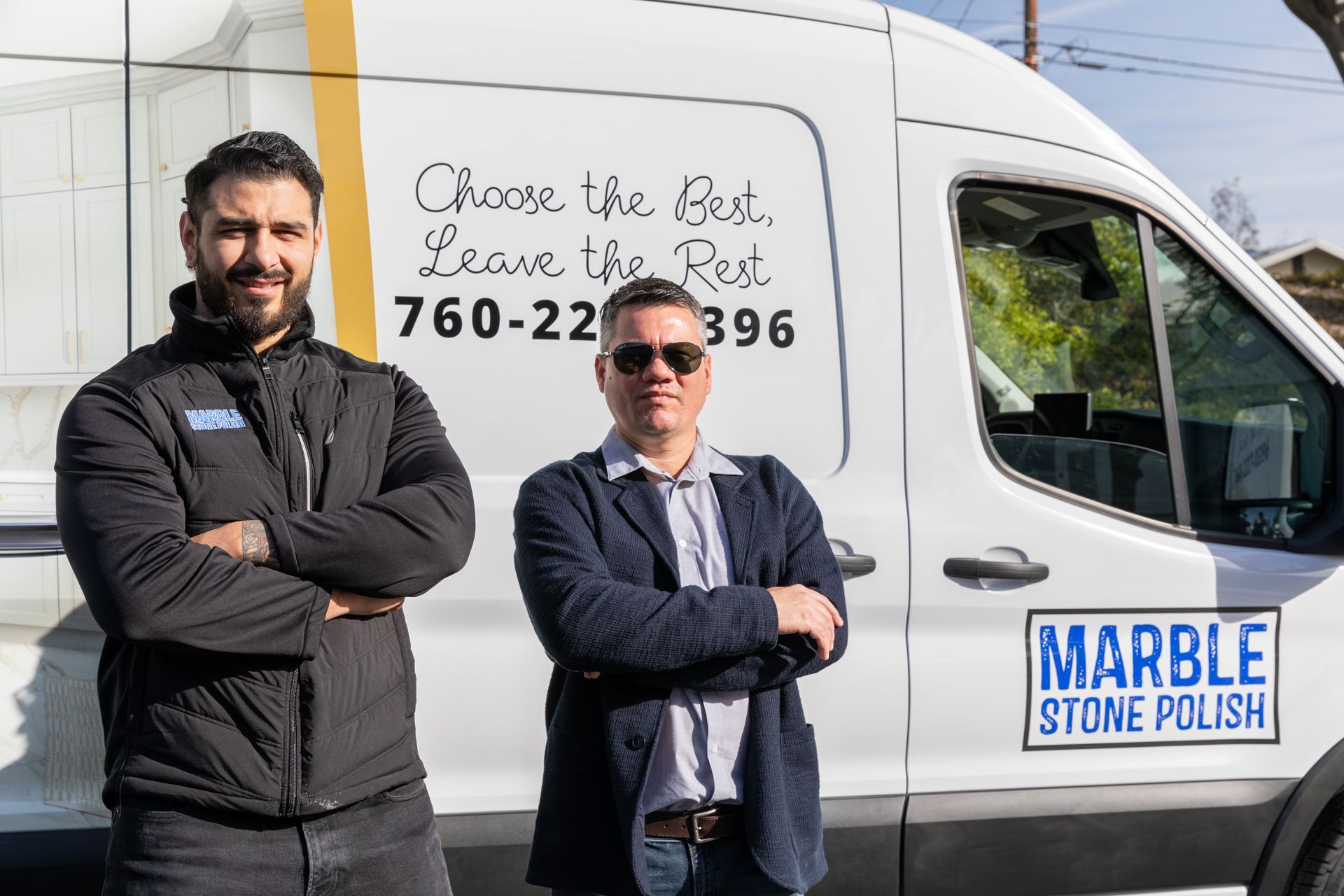 Two men standing in front of a white van with 