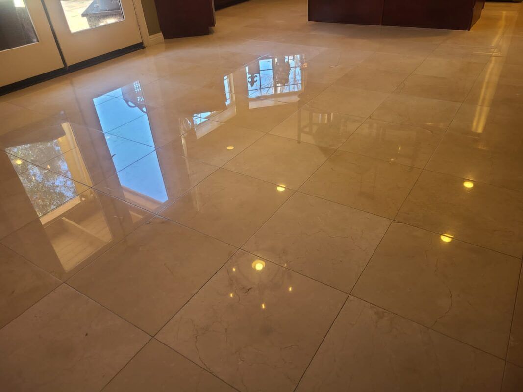Polished, light-colored square floor tiles with bright reflections from windows and interior lights.