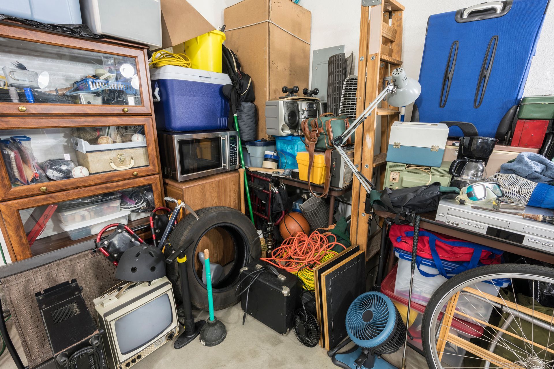 A garage filled with lots of junk and boxes.