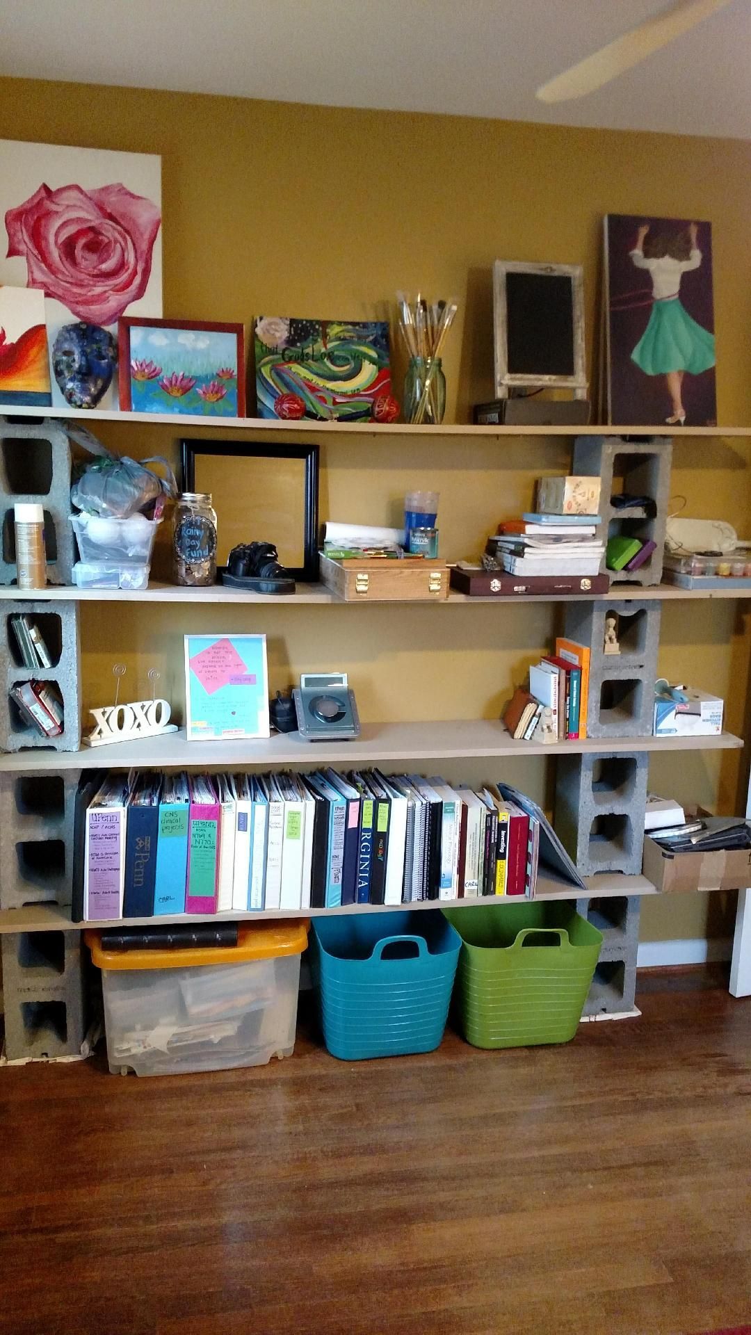 A room with a bookshelf made out of concrete blocks