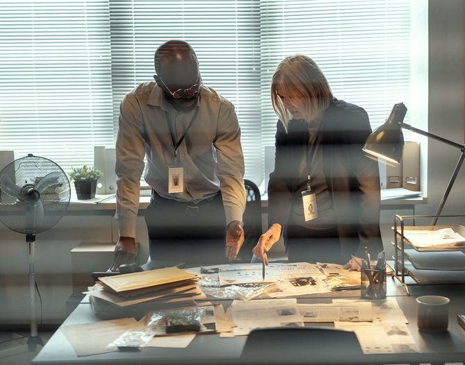 Investigators checking the documents Investigators checking the documents